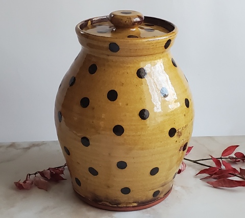 redware jar with black polka dots